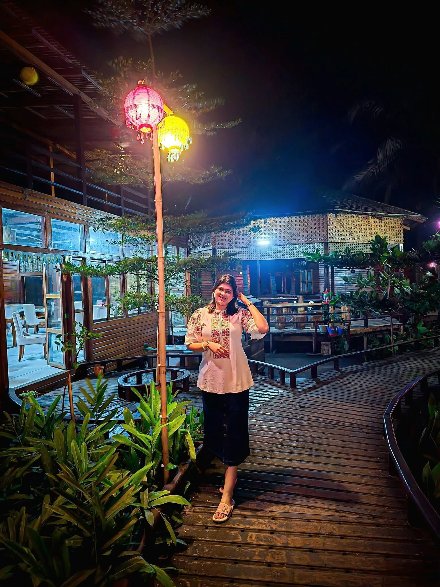Warmly lit wooden dining area and courtyard at LuiPaz Resort in the evening