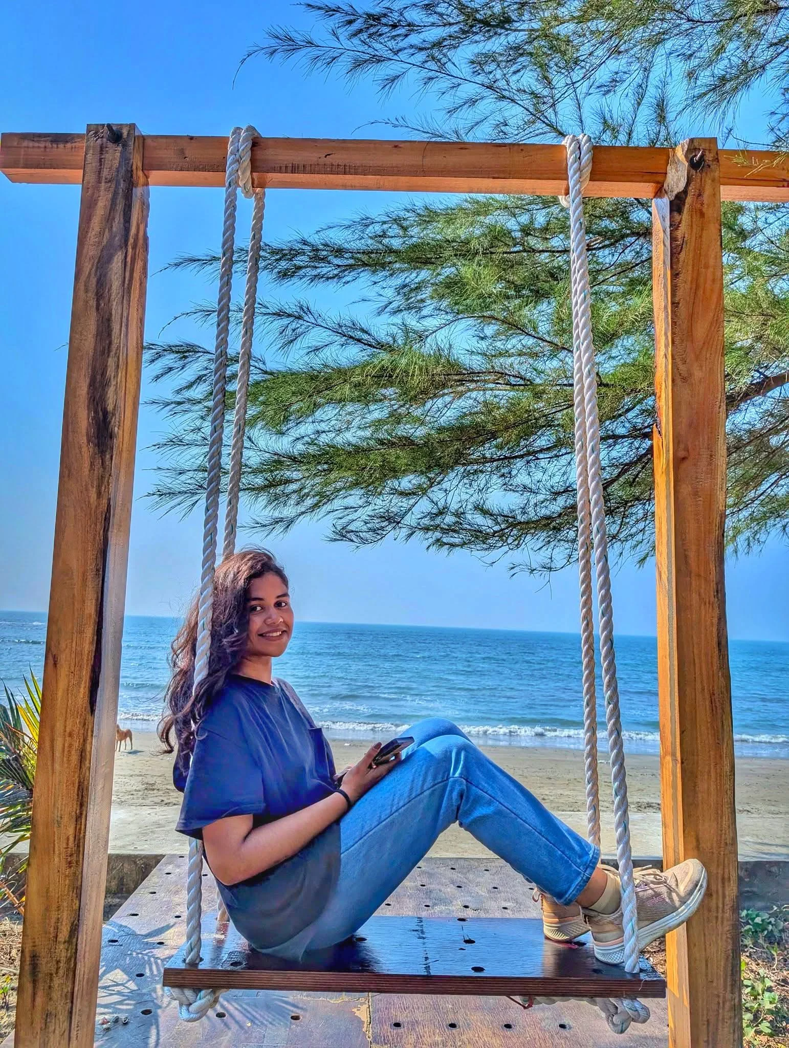 A guest enjoying an ocean-facing swing at LuiPaz Resort