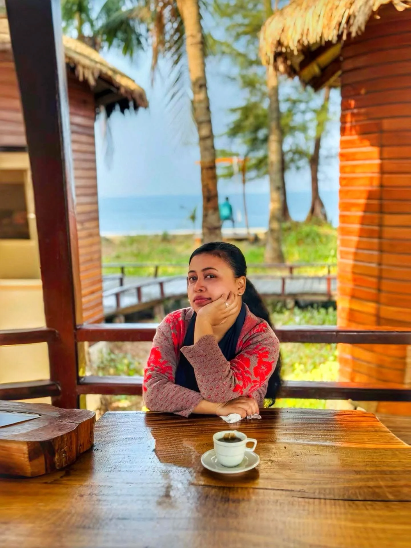 A guest beside the wooden seaside window at LuiPaz Resort